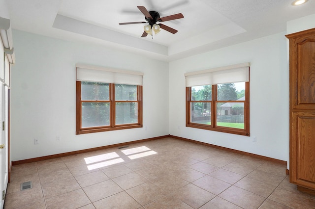 4520 English Ivy Ave, Springfield, MO 65804 - spare room with a raised ceiling, light tile patterned flooring, and ceiling fan
