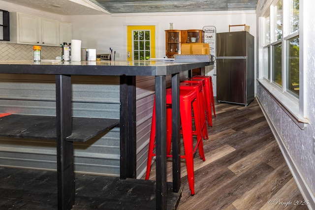 3331 US Highway 160, West Plains, MO 65775 - kitchen featuring freestanding refrigerator, dark countertops, dark wood-style flooring, tasteful backsplash, and plenty of natural light