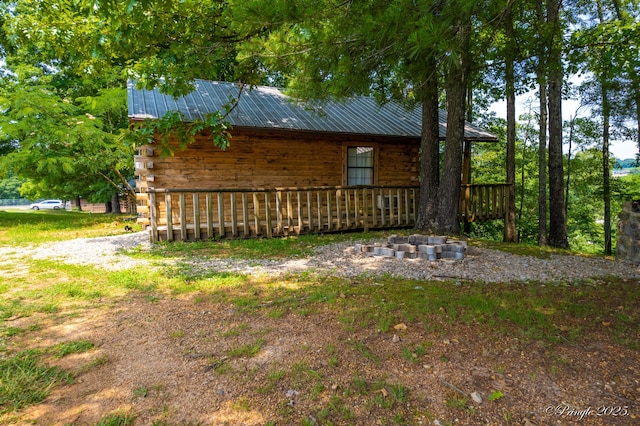 378 63rd Hwy S, Mammoth Spring, AR 72554 - view of property exterior featuring a metal roof, log siding, and covered porch