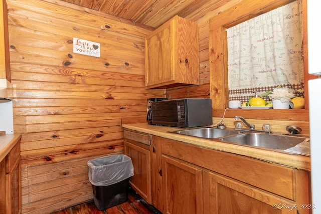 378 63rd Hwy S, Mammoth Spring, AR 72554 - kitchen with black microwave, wood ceiling, dark wood-style flooring, light countertops, and wood walls