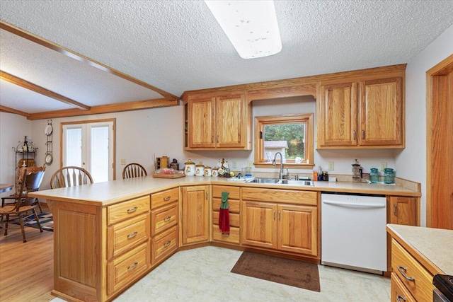 112 Riverview Dr, Anderson, MO 64831 - kitchen featuring dishwasher, a peninsula, light countertops, a textured ceiling, and brown cabinetry