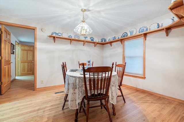 112 Riverview Dr, Anderson, MO 64831 - dining space featuring light wood-style flooring and a chandelier