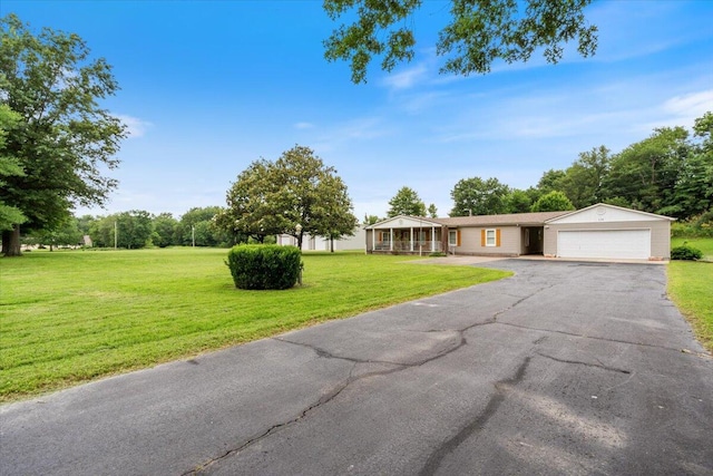 112 Riverview Dr, Anderson, MO 64831 - single story home featuring asphalt driveway, a front yard, and a garage