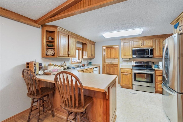 112 Riverview Dr, Anderson, MO 64831 - kitchen with stainless steel appliances, a textured ceiling, a peninsula, light countertops, and open shelves