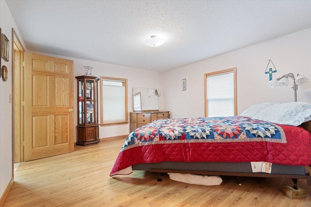 112 Riverview Dr, Anderson, MO 64831 - bedroom featuring wood finished floors and a textured ceiling