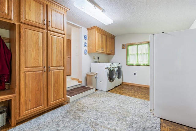 112 Riverview Dr, Anderson, MO 64831 - laundry area featuring separate washer and dryer, cabinet space, and a textured ceiling