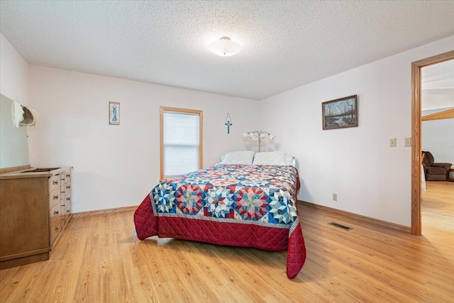 112 Riverview Dr, Anderson, MO 64831 - bedroom with wood finished floors and a textured ceiling