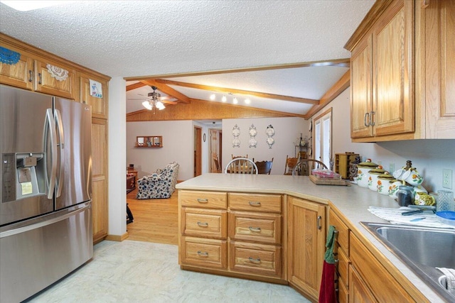 112 Riverview Dr, Anderson, MO 64831 - kitchen featuring stainless steel fridge with ice dispenser, a peninsula, lofted ceiling, brown cabinets, and ceiling fan