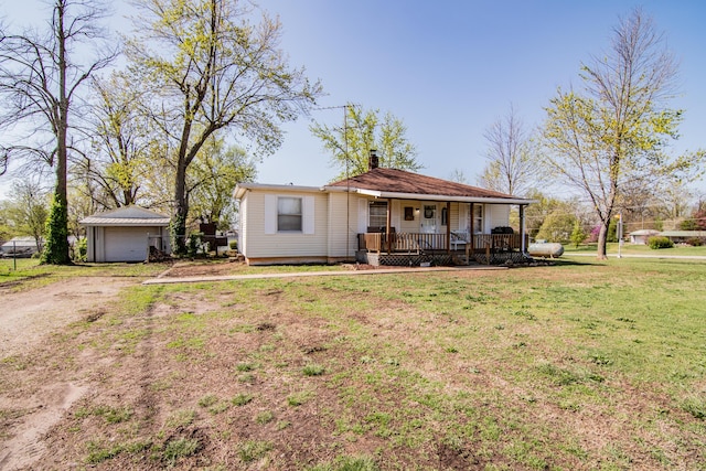 317 W 1st St, Miller, MO 65707 - ranch-style house with a porch, a detached garage, a front yard, a chimney, and dirt driveway