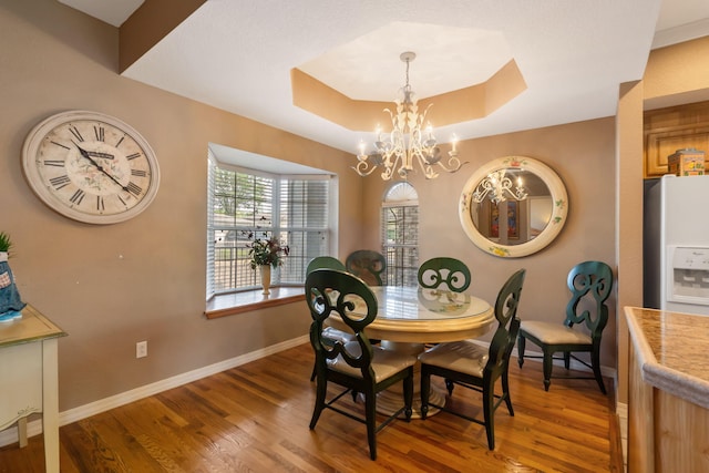 200 Glory Rd Unit 3, Branson, MO 65616 - dining space with a chandelier, wood finished floors, and a raised ceiling