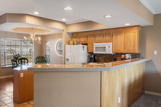 200 Glory Rd Unit 3, Branson, MO 65616 - kitchen featuring white appliances, a peninsula, tasteful backsplash, recessed lighting, and a chandelier