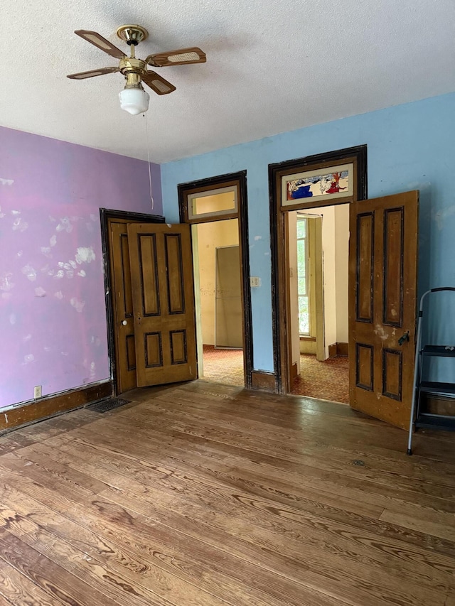 405 N Walnut St, Pierce City, MO 65723 - spare room with wood finished floors, ceiling fan, and a textured ceiling
