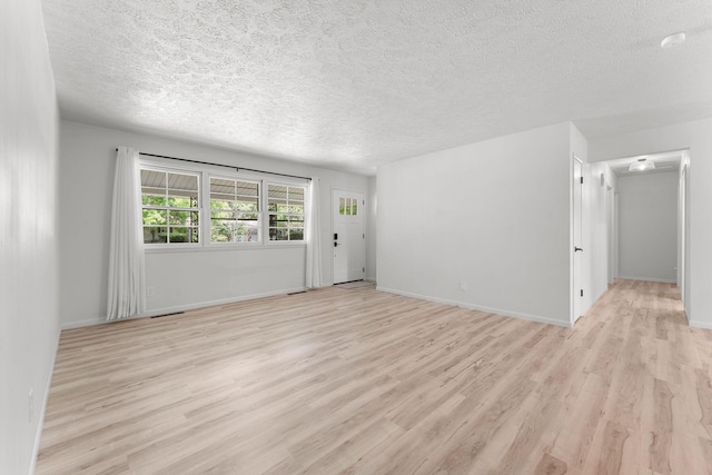2443 S Kickapoo Ave, Springfield, MO 65804 - empty room featuring light wood-type flooring and a textured ceiling