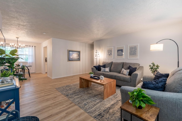 2443 S Kickapoo Ave, Springfield, MO 65804 - living area featuring a textured ceiling, a chandelier, and light wood-type flooring