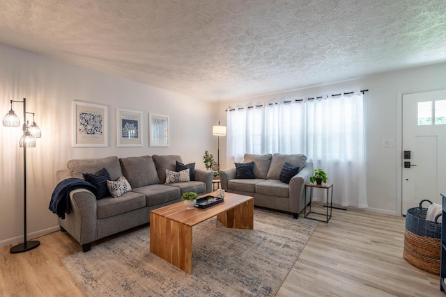 2443 S Kickapoo Ave, Springfield, MO 65804 - living room featuring a textured ceiling and light wood finished floors