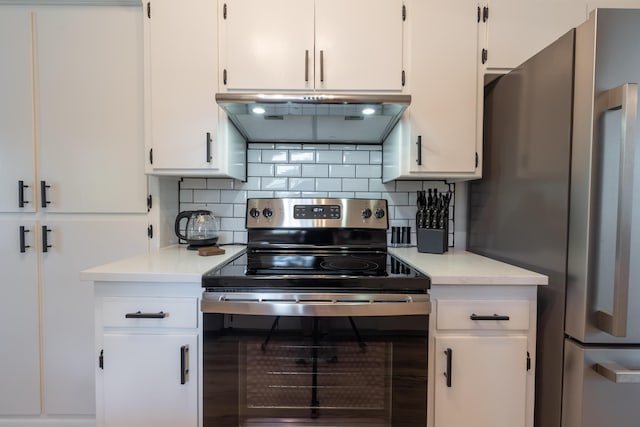 2443 S Kickapoo Ave, Springfield, MO 65804 - kitchen featuring appliances with stainless steel finishes, under cabinet range hood, light countertops, and white cabinets