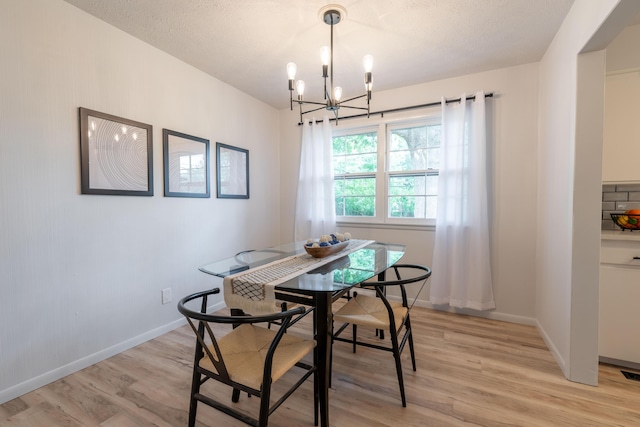 2443 S Kickapoo Ave, Springfield, MO 65804 - dining space with light wood-style flooring and a chandelier