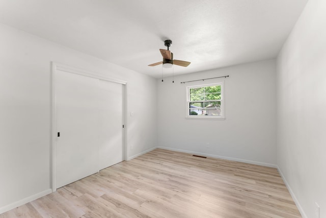 2443 S Kickapoo Ave, Springfield, MO 65804 - unfurnished bedroom with light wood-style flooring, a closet, and a ceiling fan