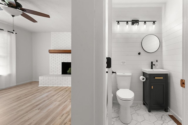 2443 S Kickapoo Ave, Springfield, MO 65804 - bathroom with a ceiling fan, vanity, a textured ceiling, and a fireplace