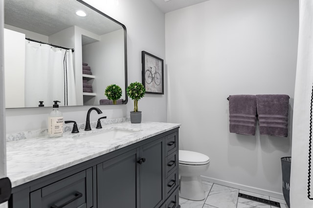2443 S Kickapoo Ave, Springfield, MO 65804 - full bathroom featuring vanity, marble finish floors, and a textured ceiling
