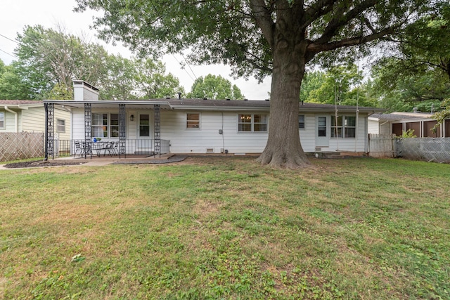 2443 S Kickapoo Ave, Springfield, MO 65804 - rear view of house featuring a patio area and a chimney