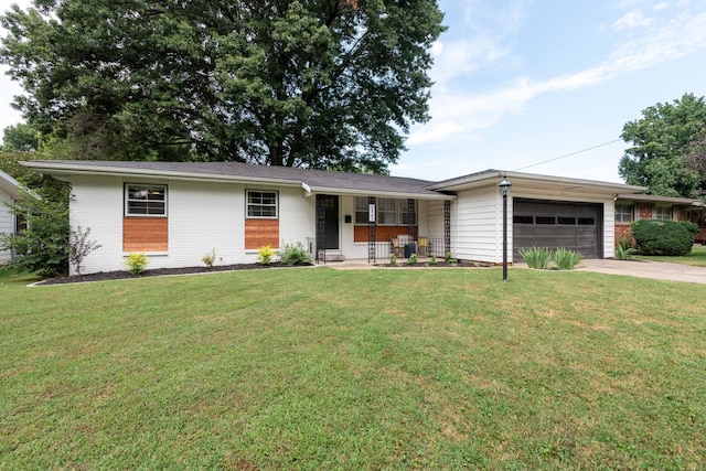 2443 S Kickapoo Ave, Springfield, MO 65804 - ranch-style home with an attached garage, covered porch, concrete driveway, and a front lawn