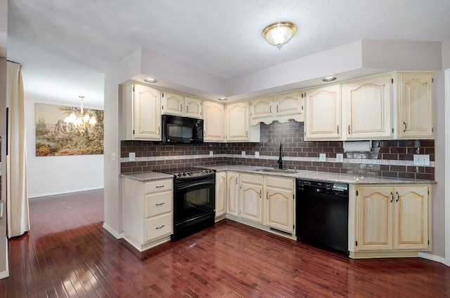 2133 E Cragmont St, Springfield, MO 65804 - kitchen featuring black appliances, cream cabinetry, a chandelier, and dark wood-style floors