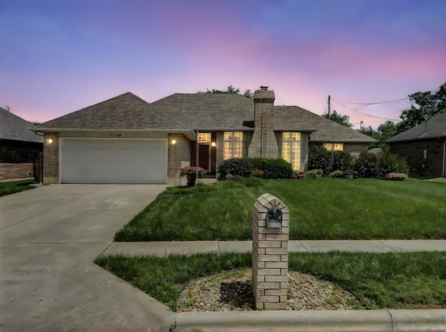 2133 E Cragmont St, Springfield, MO 65804 - single story home featuring an attached garage, a chimney, concrete driveway, a yard, and brick siding