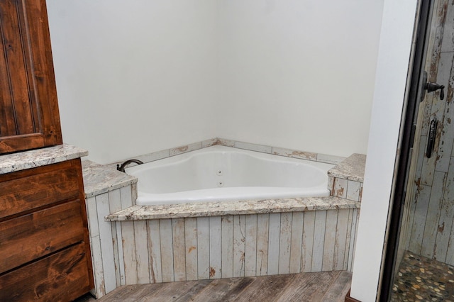 1721 Jackson Spring Rd, Ozark, MO 65721 - bathroom featuring a tub with jets and wood finished floors