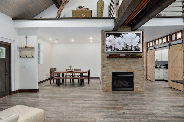 1721 Jackson Spring Rd, Ozark, MO 65721 - living room featuring a barn door, light wood-style flooring, recessed lighting, and a fireplace