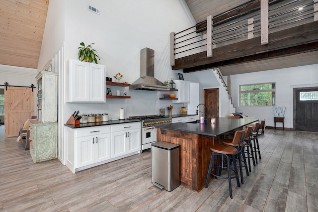 1721 Jackson Spring Rd, Ozark, MO 65721 - kitchen with island range hood, range with two ovens, open shelves, high vaulted ceiling, and dark countertops