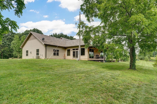 1721 Jackson Spring Rd, Ozark, MO 65721 - rear view of house with board and batten siding and a lawn
