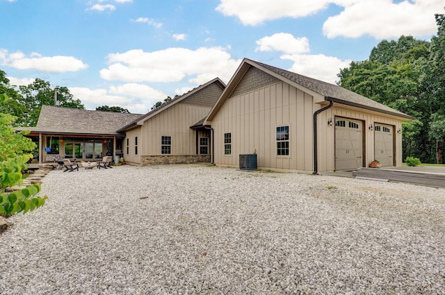 1721 Jackson Spring Rd, Ozark, MO 65721 - back of property featuring board and batten siding, an attached garage, and gravel driveway