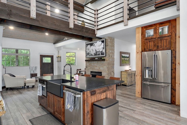 1721 Jackson Spring Rd, Ozark, MO 65721 - kitchen featuring stainless steel appliances, dark countertops, open floor plan, light wood-style flooring, and beam ceiling