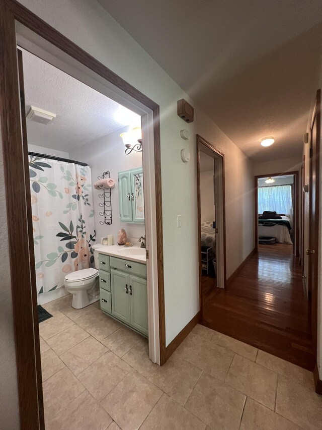1014 Sassafras St, Willow Springs, MO 65793 - ensuite bathroom featuring vanity, tile patterned floors, and curtained shower