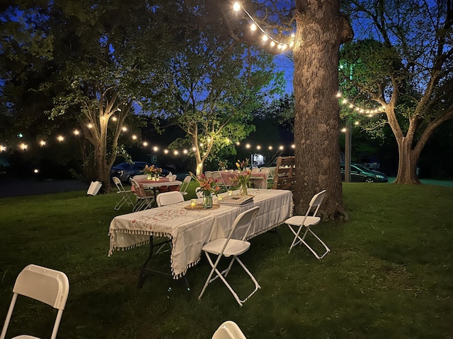 1014 Sassafras St, Willow Springs, MO 65793 - patio at night with a yard and outdoor dining area