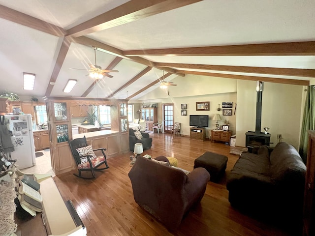 1014 Sassafras St, Willow Springs, MO 65793 - living room featuring a ceiling fan, a wood stove, and light wood-style flooring
