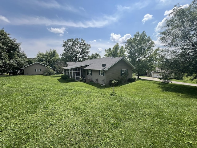 1014 Sassafras St, Willow Springs, MO 65793 - view of side of property with a sunroom, a yard, view of scattered trees, and roof with shingles