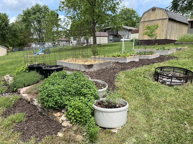 1014 Sassafras St, Willow Springs, MO 65793 - view of yard featuring a garden, an outdoor fire pit, and an outdoor structure