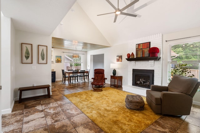 3115 E Lark St, Springfield, MO 65804 - living room with ceiling fan, stone tile flooring, a brick fireplace, and high vaulted ceiling
