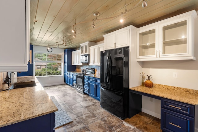 3115 E Lark St, Springfield, MO 65804 - kitchen featuring black appliances, blue cabinetry, track lighting, white cabinets, and tasteful backsplash