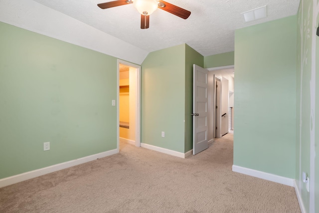 3115 E Lark St, Springfield, MO 65804 - unfurnished bedroom featuring light colored carpet, a textured ceiling, lofted ceiling, and ceiling fan