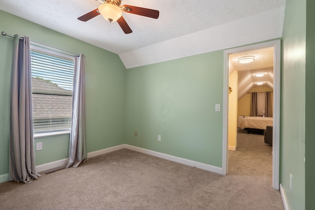3115 E Lark St, Springfield, MO 65804 - unfurnished bedroom with lofted ceiling, carpet, a textured ceiling, and a ceiling fan