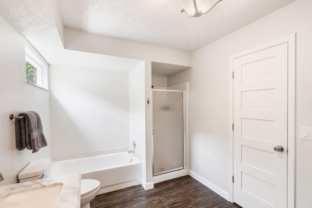 3115 E Lark St, Springfield, MO 65804 - bathroom featuring wood finished floors, a stall shower, a garden tub, and a textured ceiling