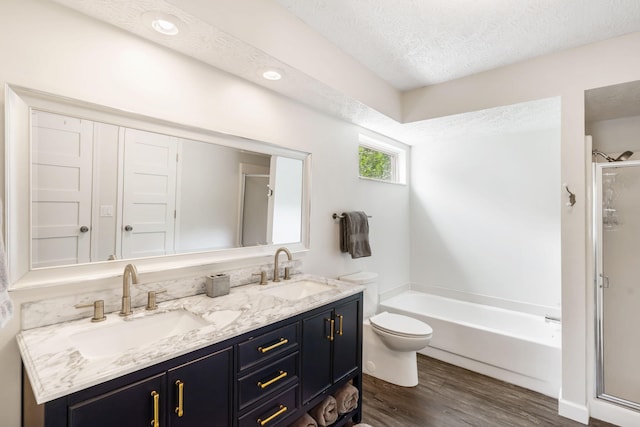 3115 E Lark St, Springfield, MO 65804 - bathroom with a stall shower, wood finished floors, a bath, double vanity, and a textured ceiling