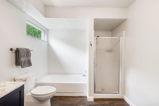 3115 E Lark St, Springfield, MO 65804 - full bathroom with wood finished floors, vanity, a bath, a shower stall, and a textured ceiling