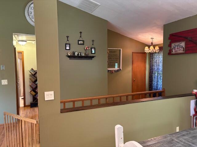 21572 Lawrence Unit 1240, Aurora, MO 65605 - dining area with a chandelier, lofted ceiling, and wood finished floors