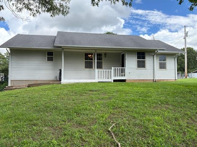 21572 Lawrence Unit 1240, Aurora, MO 65605 - rear view of house with covered porch, a yard, and roof with shingles