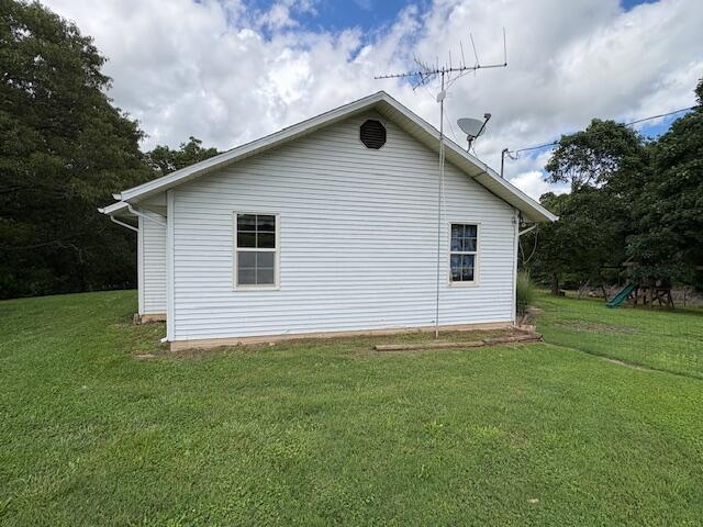 21572 Lawrence Unit 1240, Aurora, MO 65605 - view of home's exterior with a lawn