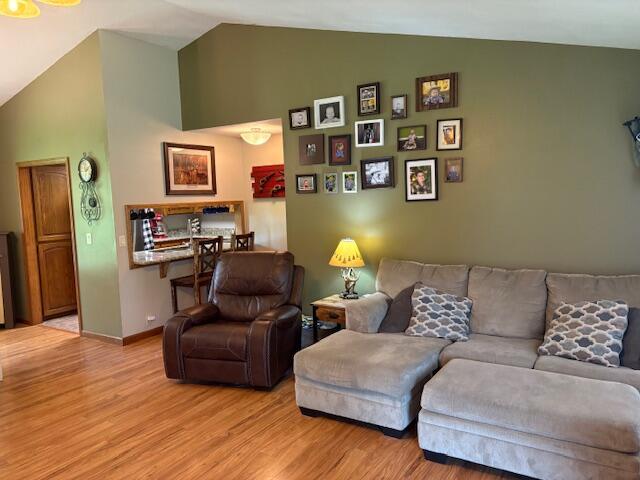 21572 Lawrence Unit 1240, Aurora, MO 65605 - living area with vaulted ceiling and light wood-type flooring